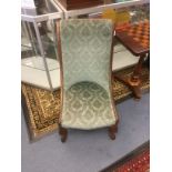 A pair of Victorian rosewood spoon back chairs, having upholstered backs and seats, with scrolled