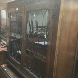 Dark wood bookcase with leaded glass doors.