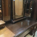 A  mid 20th Century dressing table with three drawers and mirror.