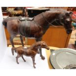 A leather covered horse with foal, 20th Century