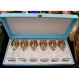 A boxed set of Italian wine glasses with gilt rims and a Rococo design