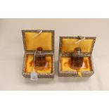 A pair of glass Chinese snuff bottles, boxed, intricately depicting town, port and country scenes