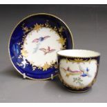 A Vincennes tea cup and saucer, painted with birds in flight within gilt cartouches on a bleu-