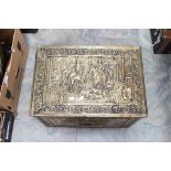 A large Victorian style brass bound rectangular coal skuttle, chased with figures, on horse