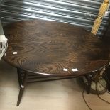 An oak 1970's rounded coffee table, along with a mahogany piano stool plus a modern piano stool