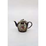 A Worcester blue lobed barrel shaped teapot and cover. Decorated with fan shaped reserves, with
