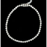 A diamond tennis bracelet, rub-over set with approx 7'', fifty six round brilliant cut diamonds,