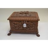 A 19th Century carved wooden table casket, on paw feet