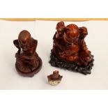 Two Chinese hardwood figures of Buddah and a figure of a man along with a Chinese snuff/scent bottle