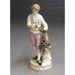 A Meissen figure of a young woodman gathering sticks in his hat, 19th Century, blue crossed