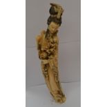 A large Chinese Guanyin ivory, late 19th/early 20th Century, carved standing holding a floral