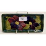 A Moorcroft 'Clematis' pattern rectangular pin dish, green ground, early 20th Century, bearing the