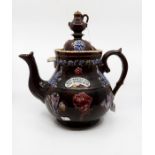 A Bargeware teapot with coffee pot finial (spout brokers but present), applied roses, Prince of