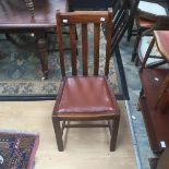 A set of four 20th Century oak leather seated dining chairs (4)