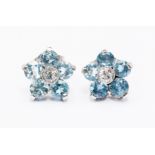 A pair of aquamarine and diamond flower cluster earrings, set with round stones and a diamond set