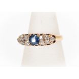 A Victorian and diamond set ring, the central cushion cut sapphire approx 0.45ct, with five old