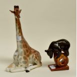 Two 20th Century Russian earthen ware figures, one a bear on wheel, and a large giraffe, marked on