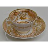 An English Porcelain London Shaped Tea Cup and Saucer. Apricot ground overlaid with gilding. Circa