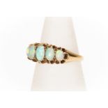 An opal and 18ct gold ring, comprising five graduated oval opals, green play of colour, size M,