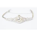 A ladies vintage diamond set cocktail watch, unmarked white metal probably platinum, on later