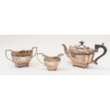 A silver three piece tea set, the pot engraved with presentation inscription, Birmingham 1921 (V&