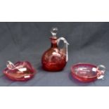 A cranberry glass decanter with stopper and two cranberry bowls with handles (3)