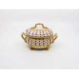A Derby Tureen and Cover decorated with floral and gilt with gilded handles and feet.  Red mark