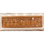An Asian carved soft fruit-wood depicting various deities in perspex box frame