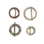 MA Mixed lot of four cast copper-alloy Medieval annular brooches, dating c. 1200-1400. Two plain,