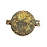 A complete cast copper-alloy folding mirror case dating to the Medieval period, c. 1150-1400. The