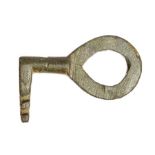 A complete cast copper-alloy later Early Medieval slide key dating c. AD 900-1100. The key