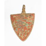 A complete cast copper-alloy and enamel harness pendant dating to the Medieval period, c. 1200-1400.