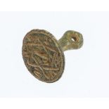 A complete cast copper-alloy seal matrix dating to the Medieval period, c. 1300-1400.The seal is