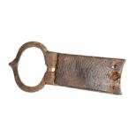An incomplete cast copper-alloy forked spacer buckle dating to the Medieval period, c. 1250-1400.
