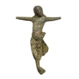 A cast copper-alloy figurine depicting Christ crucified, dating c. 1100-1300. The figurine is