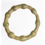 A complete cast copper-alloy harness ring or strap distributor of probable Late Iron Age or Early