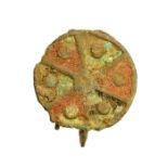 A virtually complete cast copper-alloy and enamel disc brooch dating to the Roman period, c. 2nd