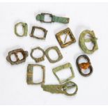 Twelve buckles and related items, mostly Medieval (c. 1250-1400). Of note in this lot: a Medieval