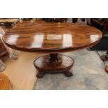 An early Victorian walnut tilt top breakfast table, oval shaped on fluted neck support, oval base on