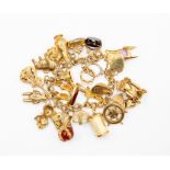 A 9ct gold and unmarked yellow metal charm bracelet, various charms, to include seals, guitar,