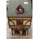 A German style dolls house in the form of a hunting lodge, with contents to the interior