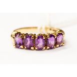 An amethyst five stone set oval, set in 9ct gold, size R, total gross weight 3.2 grams approx