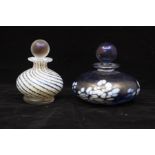 Two Isle of Wight glass perfume bottles, one purple and white and one goid and blue line design (