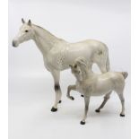 A large Beswick dapple grey horse along with a smaller version