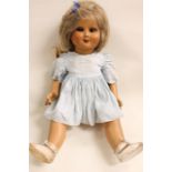 A mid 20th century composition doll, unmarked, flirty eyes, closed mouth, fingers intact,