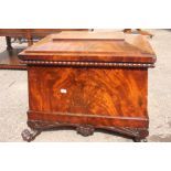 A Regency mahogany sarcophagus cellar ,platform lid above beaded decoration supported on claw