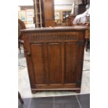 A 20th Century  small oak cupboard with linenfold decorative carving.