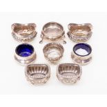Eight silver salts pots, three pairs one pair with blue glass liners and two others one  Victorian