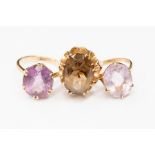 A collection of three 9ct gold dress rings, one set with smoky quartz the others with amethyst,