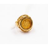 A two pesos coin ring, 1945, mounted in 9ct gold, fancy scrolling mount, size K, total gross